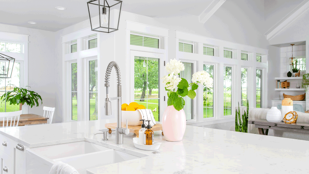 Big White Kitchen with marble countertops and windows on every wall