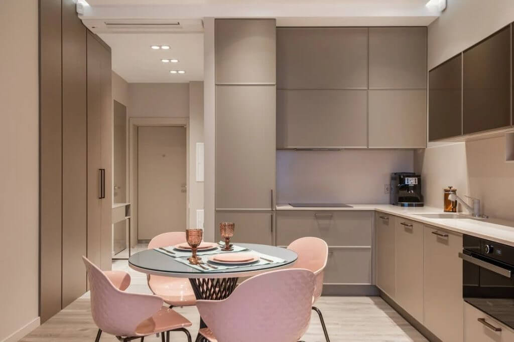 Monochrome kitchen with pink dining set