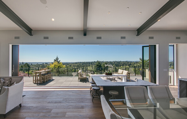 Living room and kitchen with big folding doors wall open to let sunlight in