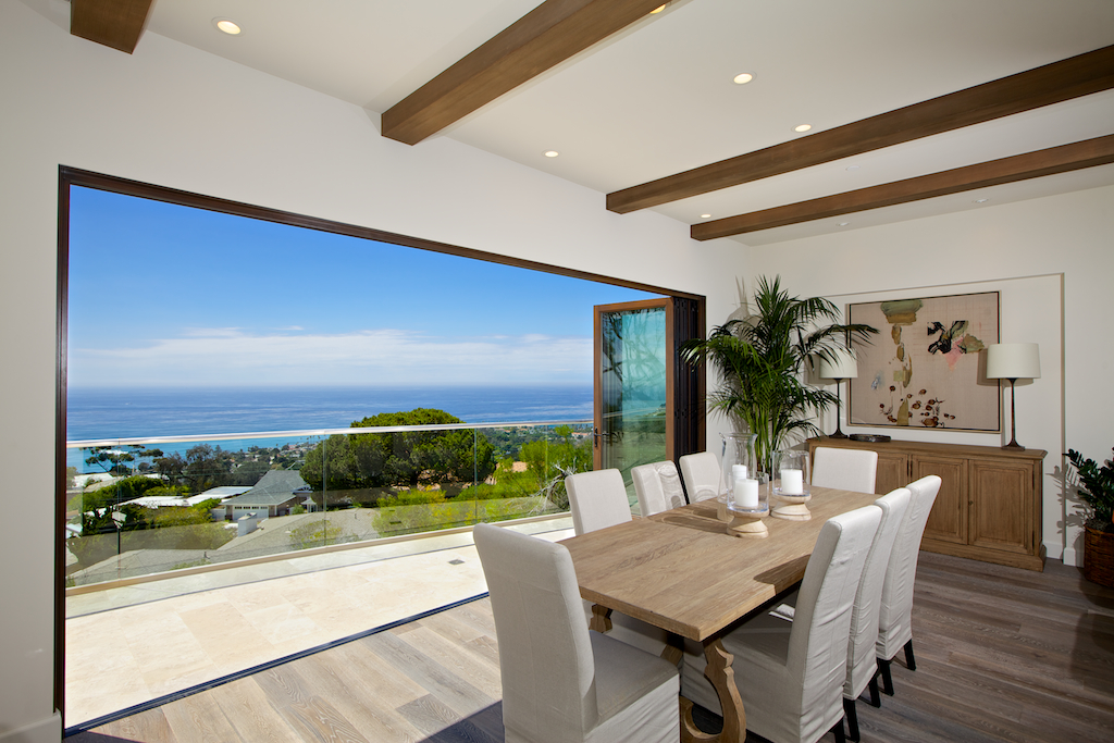 A LaCantina Contemporary Clad Bifolding door system overlooking the Pacific, showcasing the engineering required for high-performance San Diego windows.
