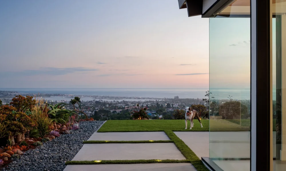 Fleetwood zero post corner glass at dusk overlooking Mission Bay from a Pacific Beach midcentury modern home