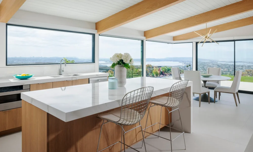 Kitchen with a waterfall island and corner windows framing panoramic views of Mission Bay